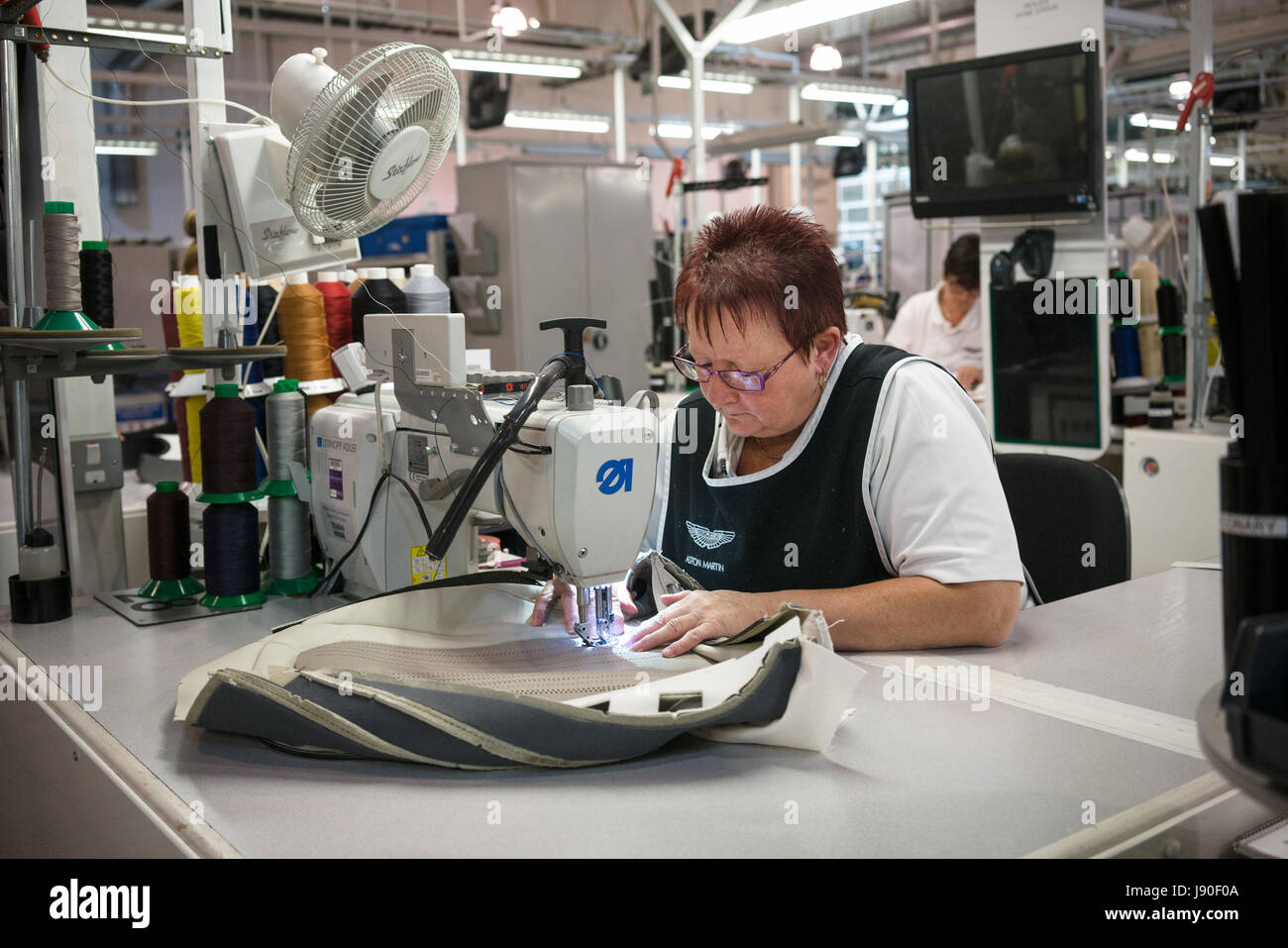 Gaydon, UK 08/10/2016. A seamstress adds detailed stitching to part