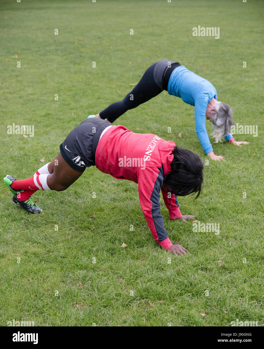 Maggie and Lucy warm up on the Saracens rugby grounds before having a