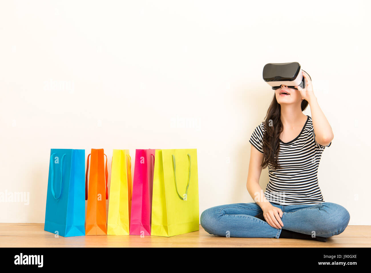 young girl adjusting the VR headset device to browsing online shopping