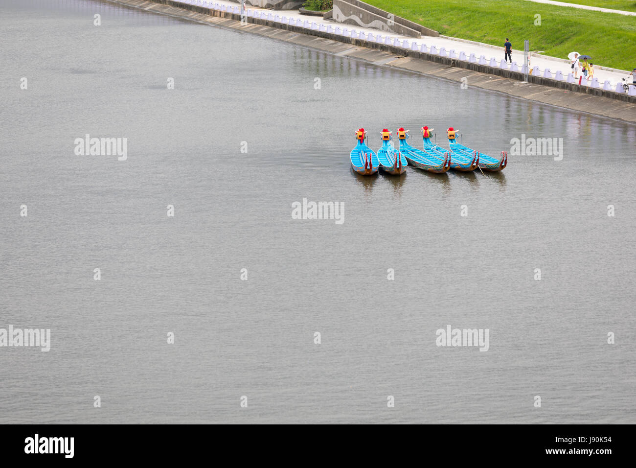 Taipei, Taiwan. 30th May, 2017. Visitors to this year's dragon boat races that take place on Keelung River in Taipei every year on Duanwu Festival, better known as Dragon Boat Festival, walk along Keelung River past five dragon boats anchored on the river on May 30. Credit: Perry Svensson/Alamy Live News Stock Photo