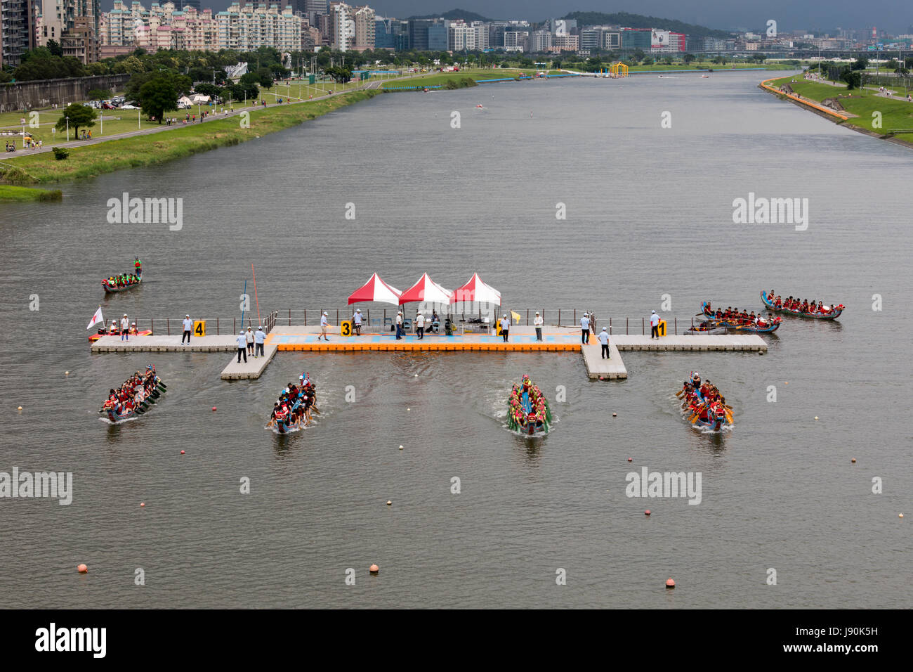 Taipei, Taiwan. 30th May, 2017. Four dragon boats leave the start platform as a heat begins at the dragon boat races that take place on Keelung River in Taipei every year on Duanwu Festival, better known as Dragon Boat Festival. Credit: Perry Svensson/Alamy Live News Stock Photo