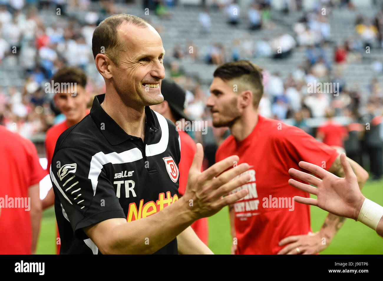 Regensburg's coach Heiko Herrlich celebrates after the German Bundesliga 2nd division relegation soccer match between TSV 1860 Munich and Jahn Regensburg in the Allianz Arena in Munich, Germany, 30 May 2017. Photo: Andreas Gebert/dpa Stock Photo