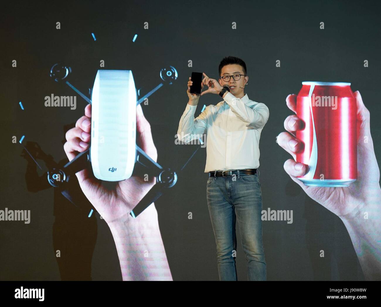 Beijing, China. 31st May, 2017. Deng Ruihao, brand manager in marketing department of Chinese drone manufacturer DJI, introduces the palm-sized drone 'Spark' during a press meeting event in Beijing, capital of China, May 31, 2017. The mini drone 'Spark' made its debut in China on Wednesday. Credit: Chen Jianli/Xinhua/Alamy Live News Stock Photo