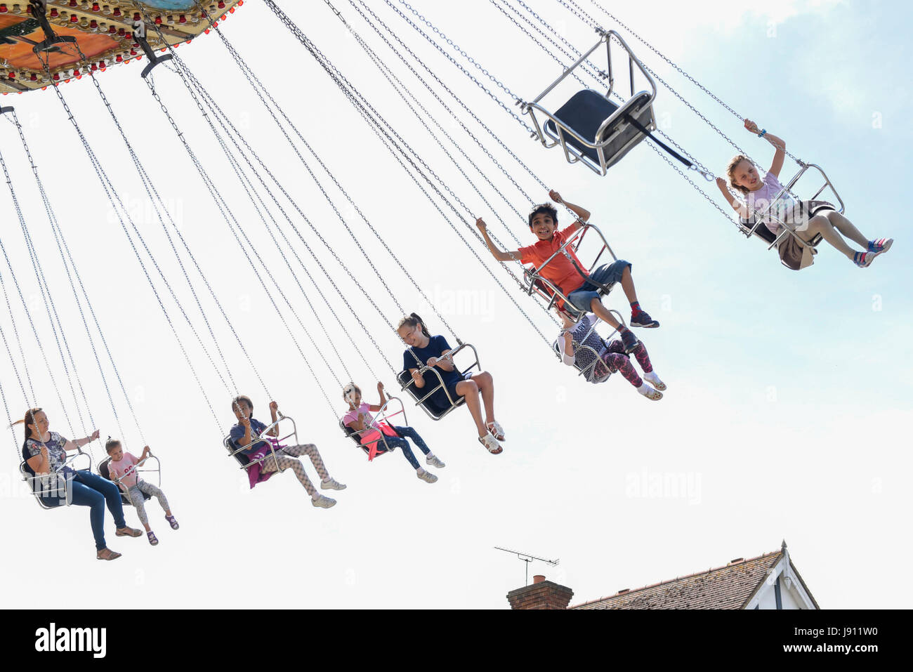 London, UK. 31 May 2017. Customers fly overhead on a spinning ride ...