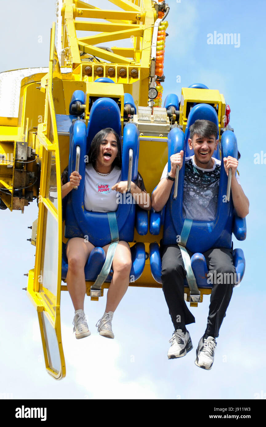 London, UK. 31 May 2017. Customers fly overhead on a spinning ride ...