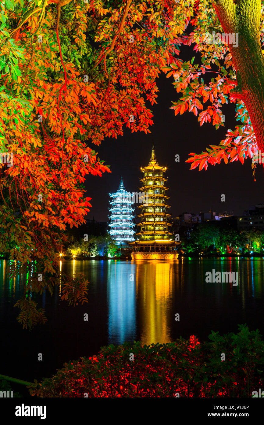 Guilin, China.  Sun and Moon Pagodas beside Shan Lake at Night. Stock Photo
