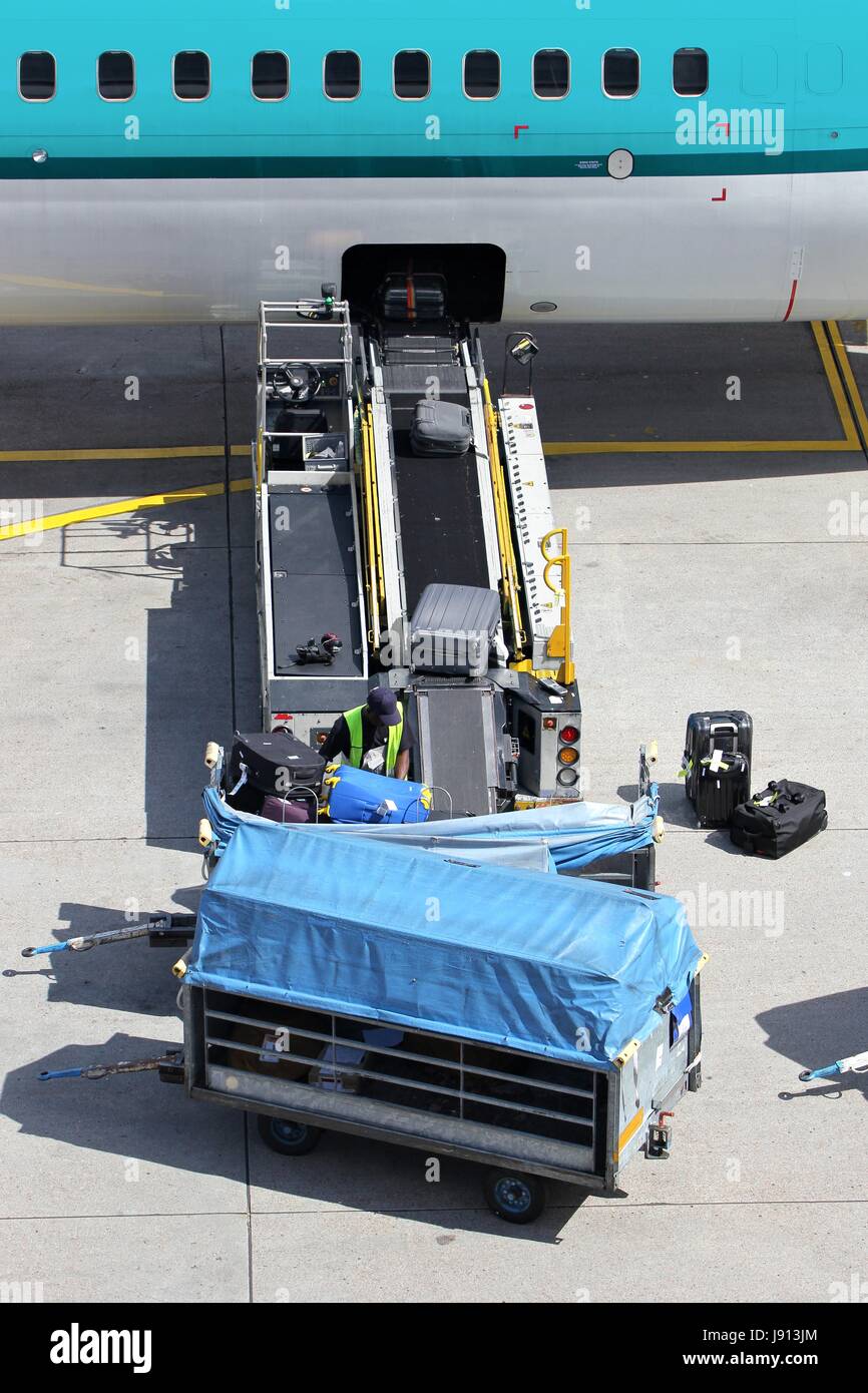 loose luggage being loaded into narrow body aircraft Stock Photo