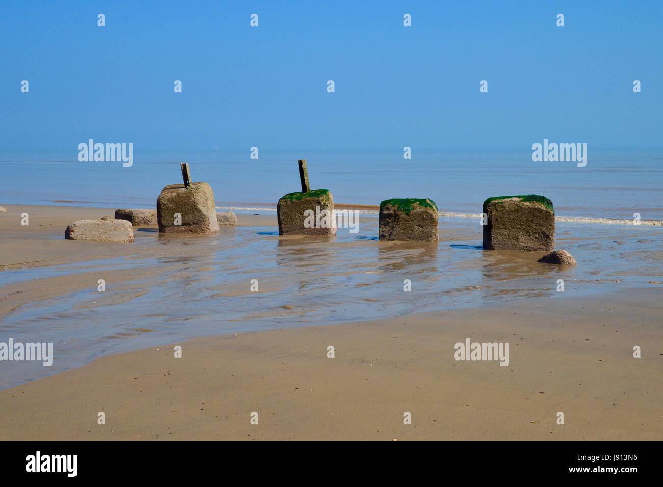 Old Sea Defences on the Beach. Stock Photo