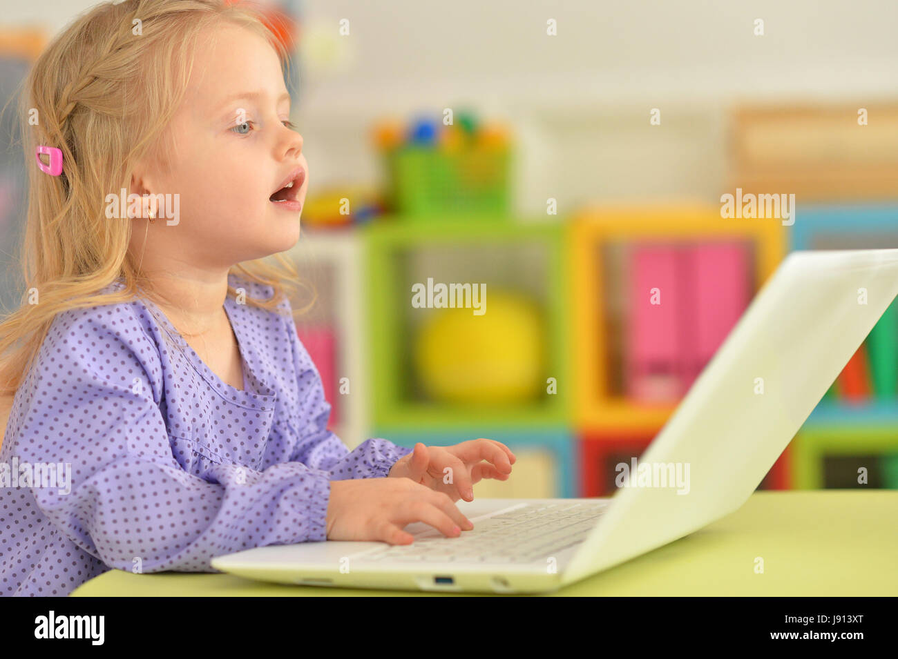 Portrait of adorable little girl using modern laptop Stock Photo - Alamy