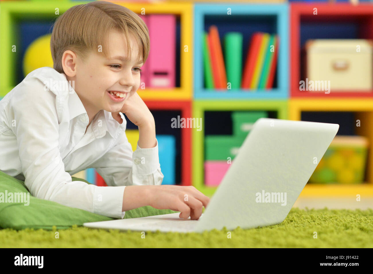 Portrait of a cute boy with a laptop Stock Photo - Alamy