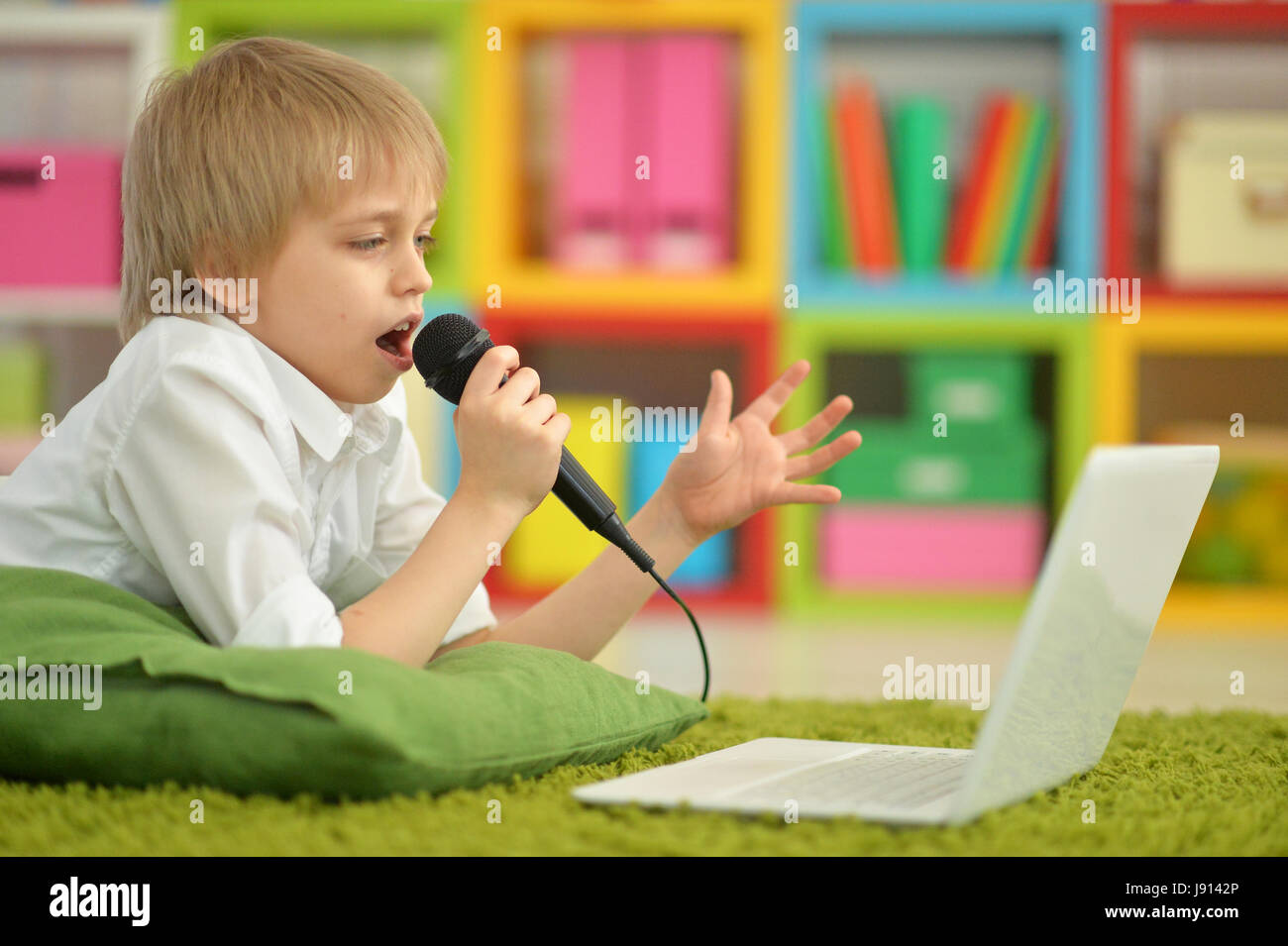 Portrait of a teenage boy with a laptop Stock Photo - Alamy