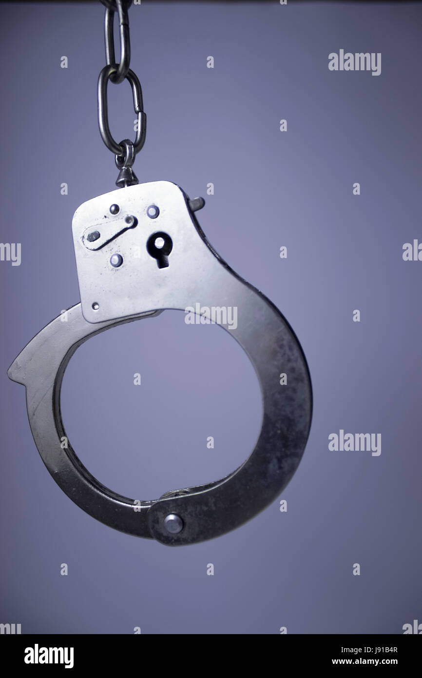 handcuffs hanging closeup Stock Photo