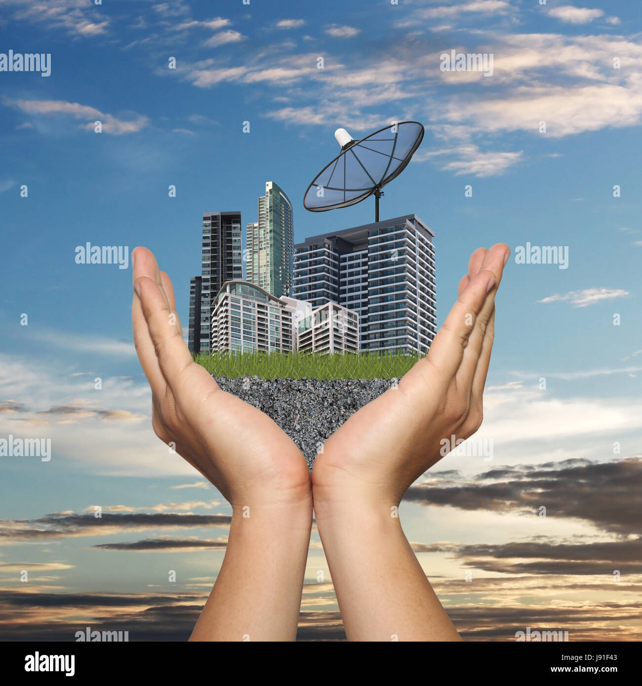 Black Satellite dish in hand of businessman and have Skyscraper on sunset background,Concept of data communication. Stock Photo