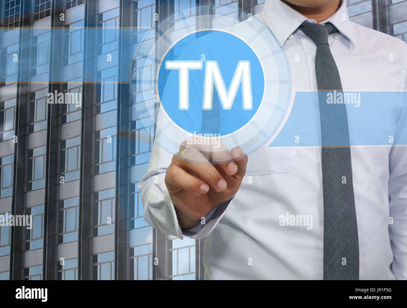 Finger of young businessman point to the blue trademark icon for design business concept. Stock Photo