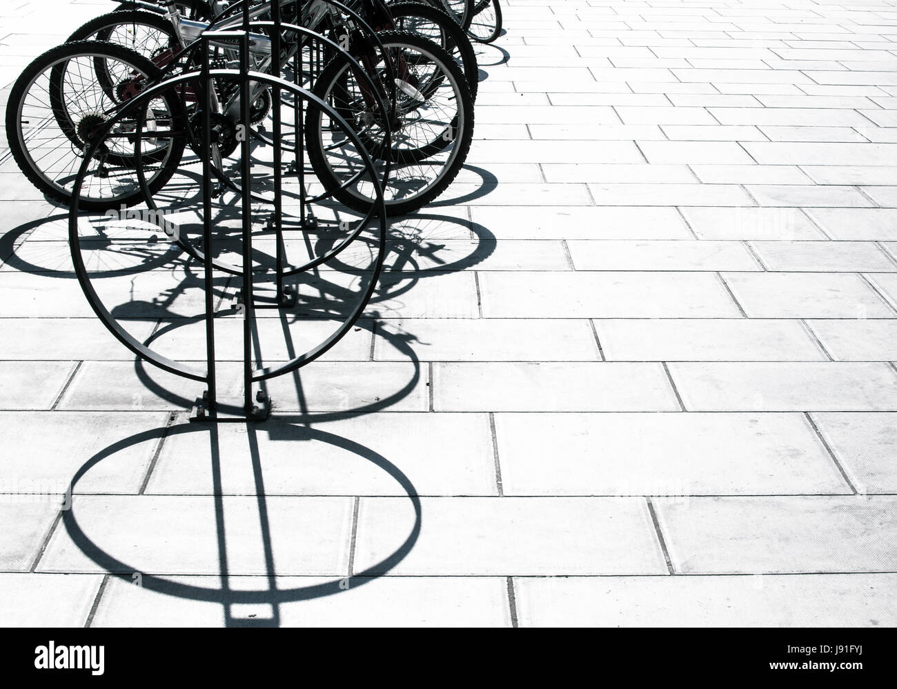 bicycles and shadows in strong sunlight Stock Photo