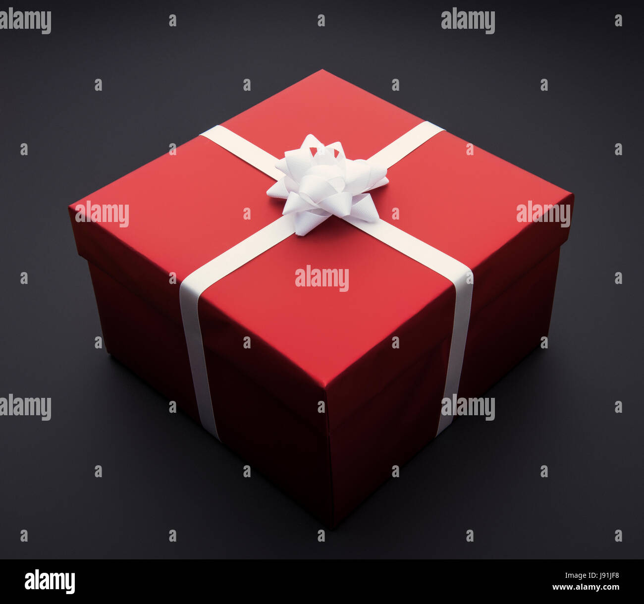 Present box wrapped in red with bow Stock Photo