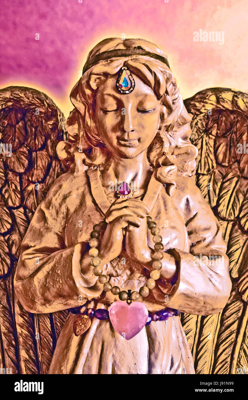 Golden Angel Statue in Prayer with eyes closed Stock Photo