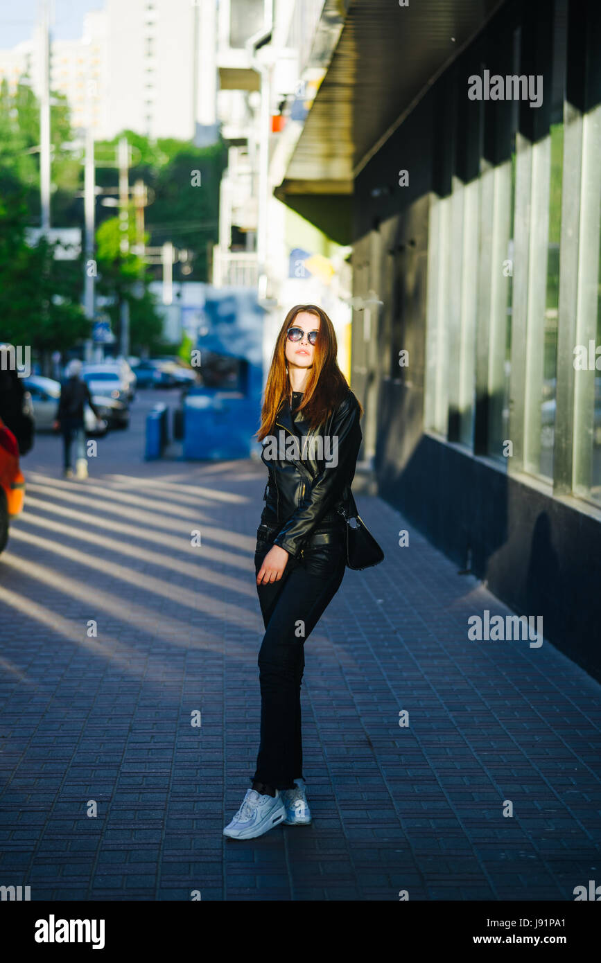 Young beautiful brunette in a city street enjoy her time Stock Photo