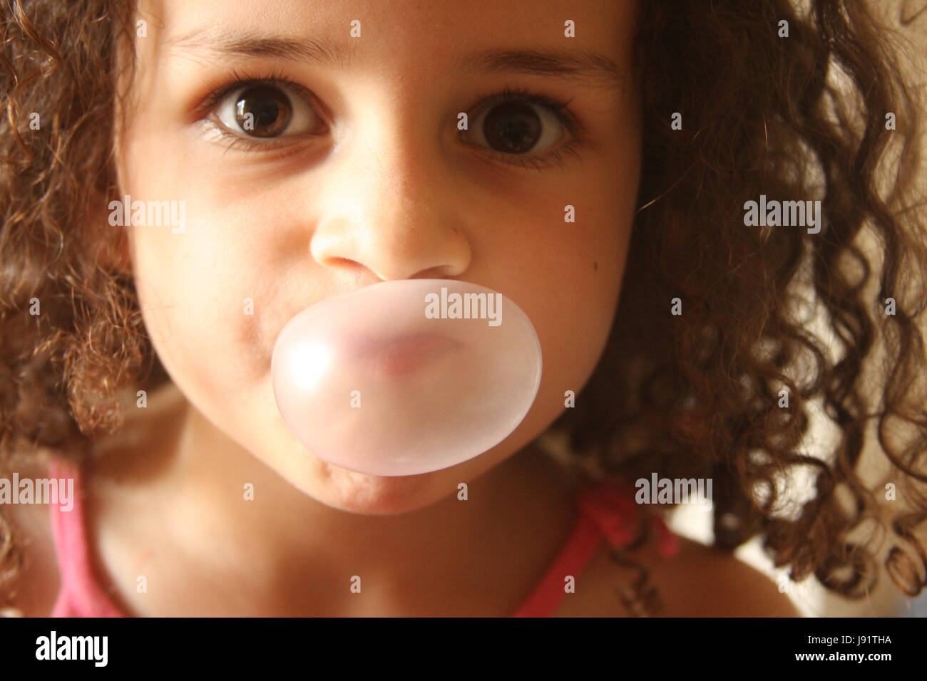Little girl blowing bubbles from bubble gum Stock Photo Alamy