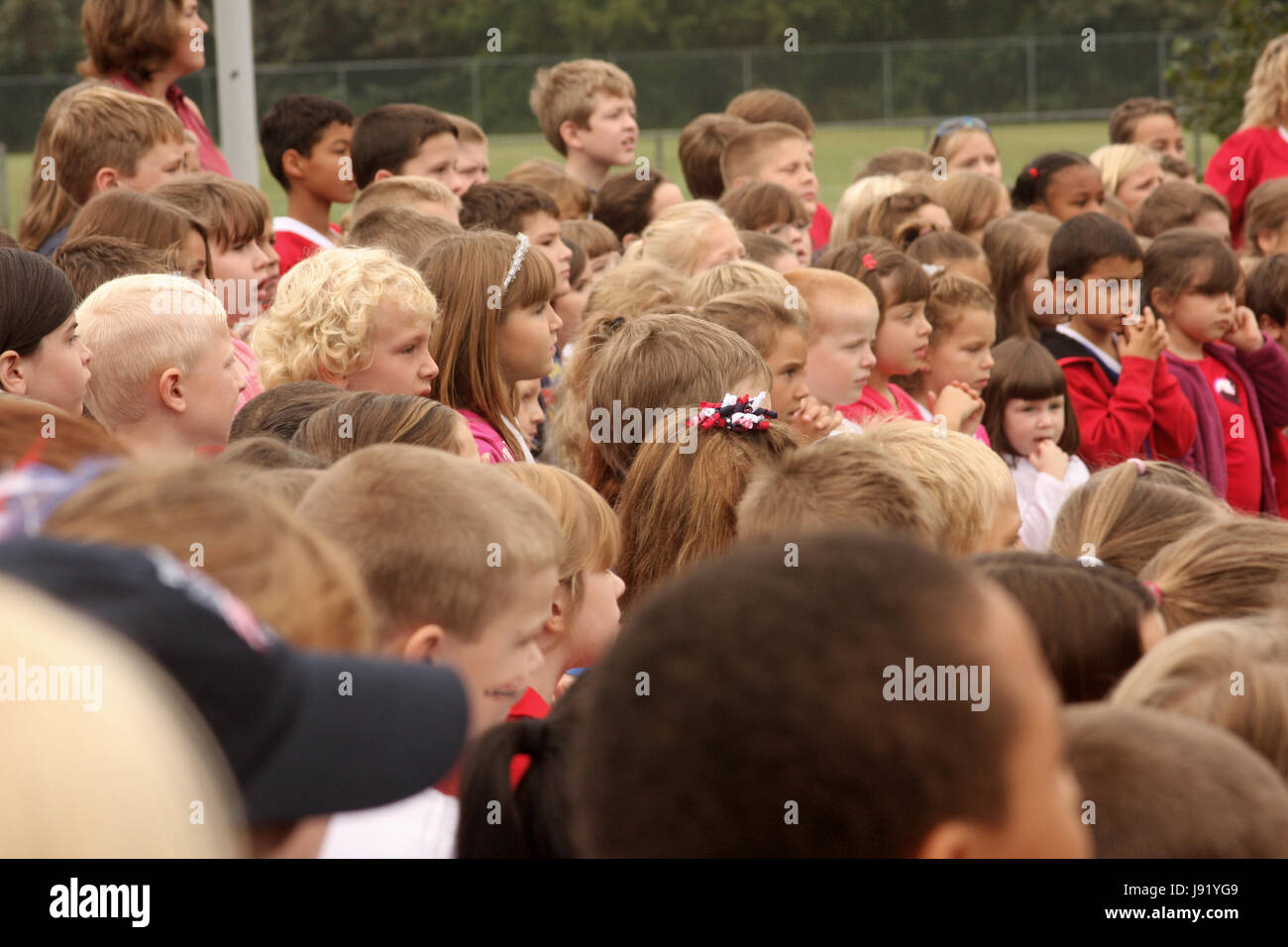 young children having an assembly outdoors Stock Photo