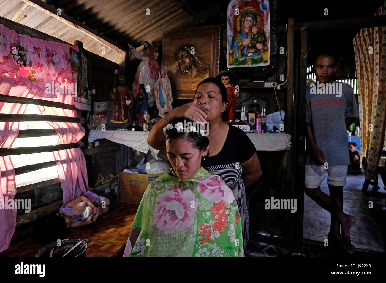 A Mananambal spiritual healer performs a healing ritual on a young