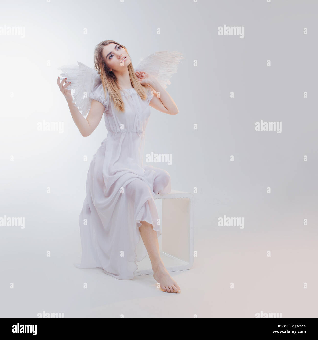 Young woman angel sitting hi-res stock photography and images - Page 3 -  Alamy