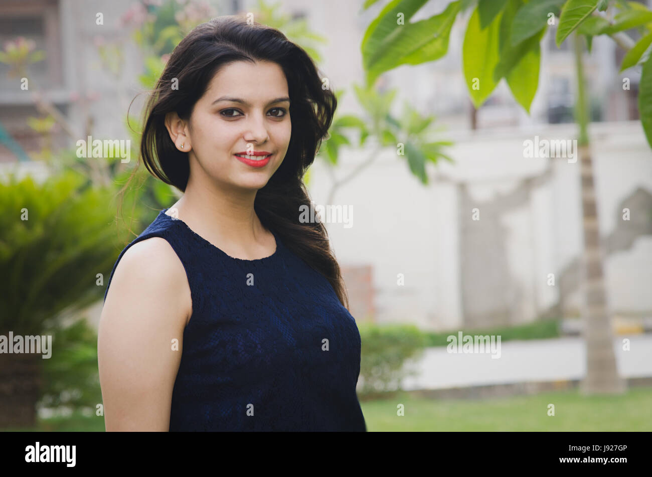 asian girl smiling while posing in a park wearing blue dress Stock ...