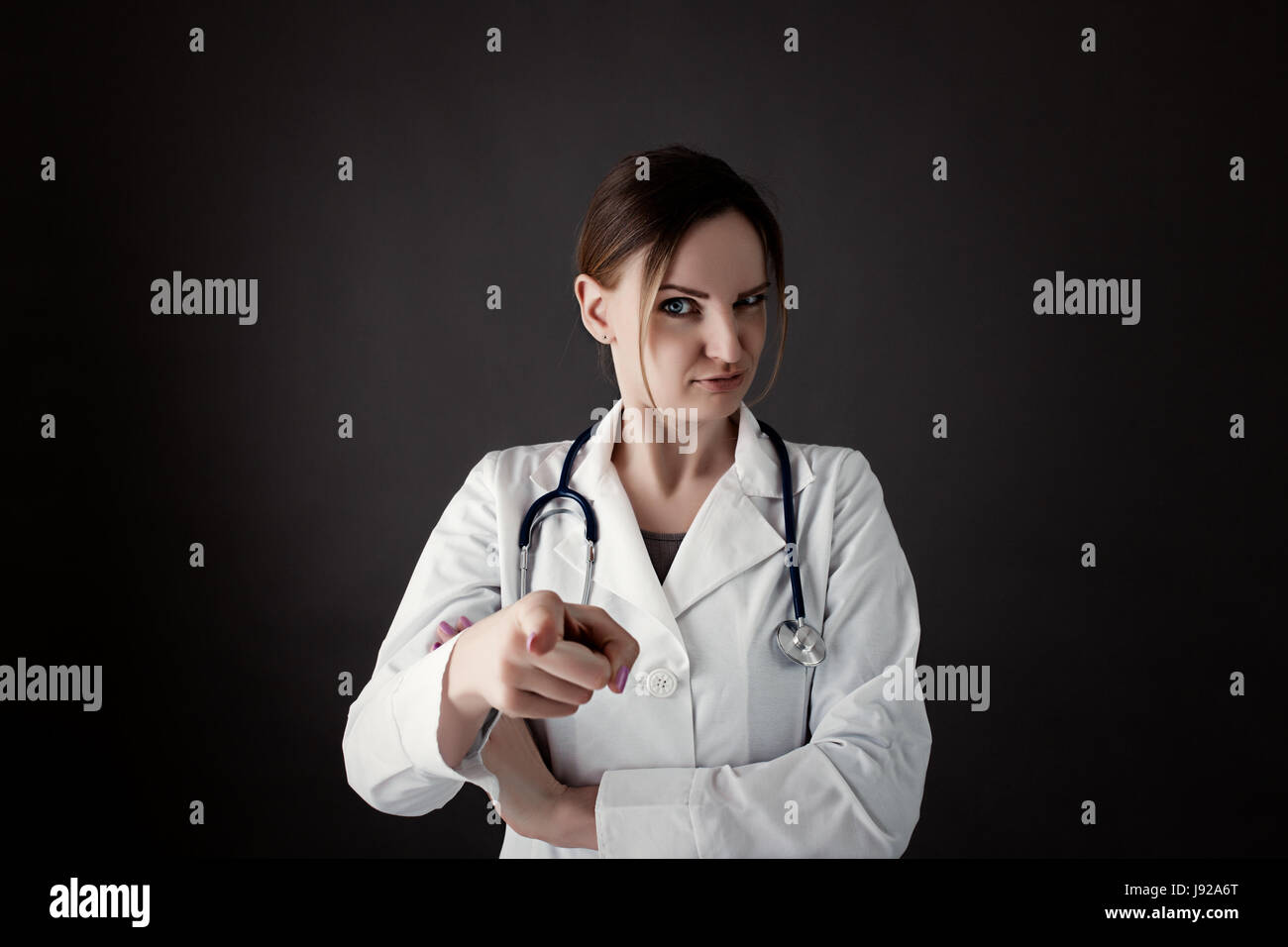 Radiology, gynecology, therapeutic or traumatology concept. Medical care or insurance concept. Female Intern hold stethoscope and smiling. phonendosco Stock Photo