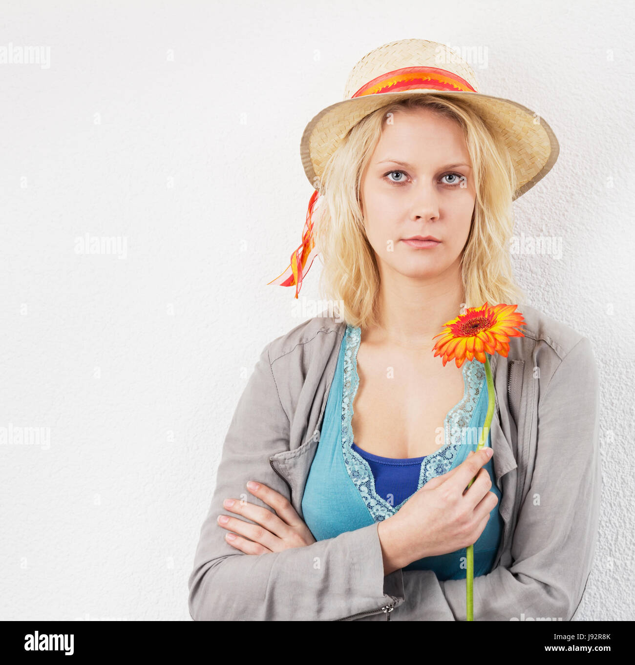 waiting young woman with flower and sun hat Stock Photo