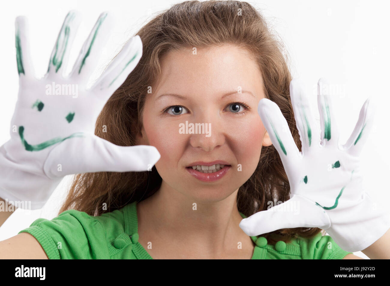 young woman playing theater with two smiley gloves Stock Photo