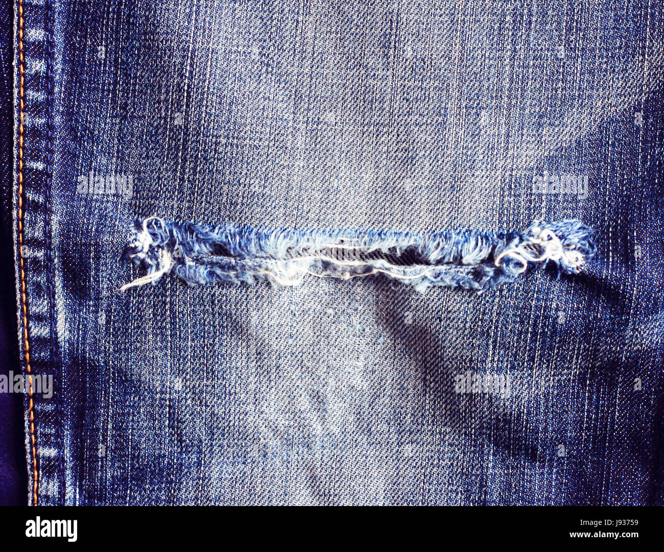 Ripped vintage jeans, Texture of vintage blue jeans background Stock Photo