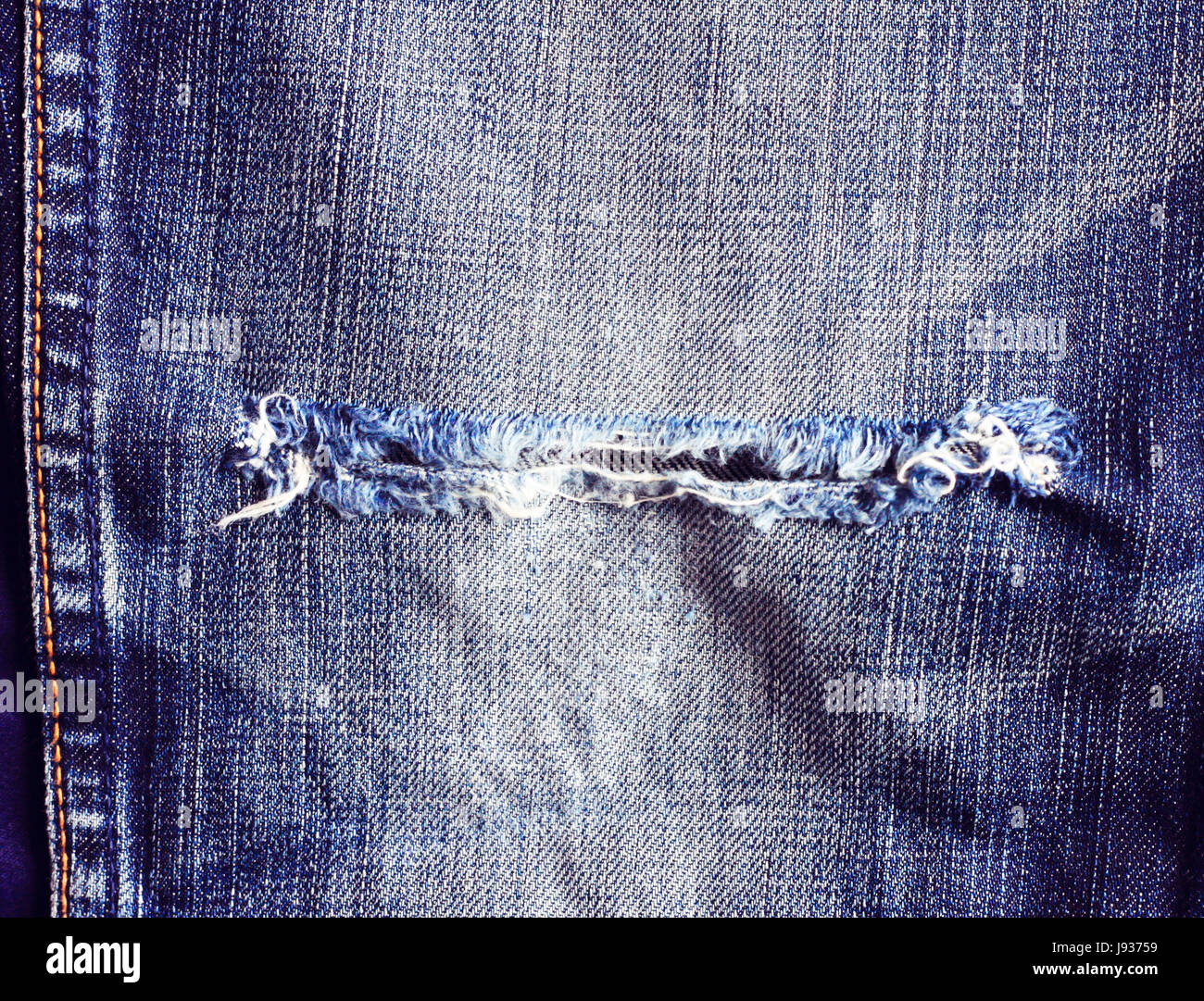 Ripped vintage jeans, Texture of vintage blue jeans background Stock