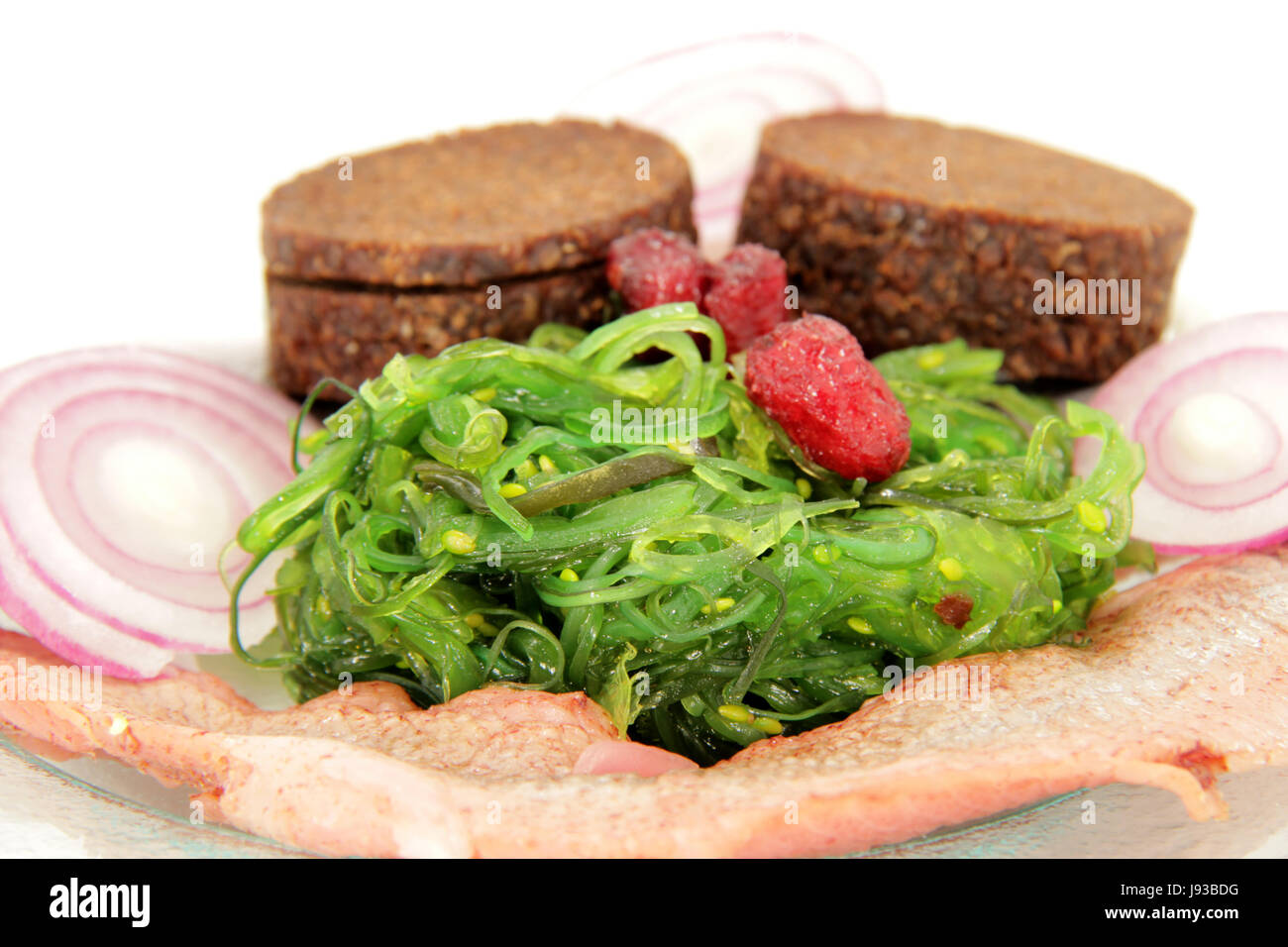 matjes herring on seaweed salad Stock Photo Alamy