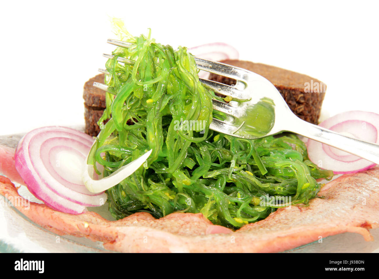 matjes herring on seaweed salad Stock Photo