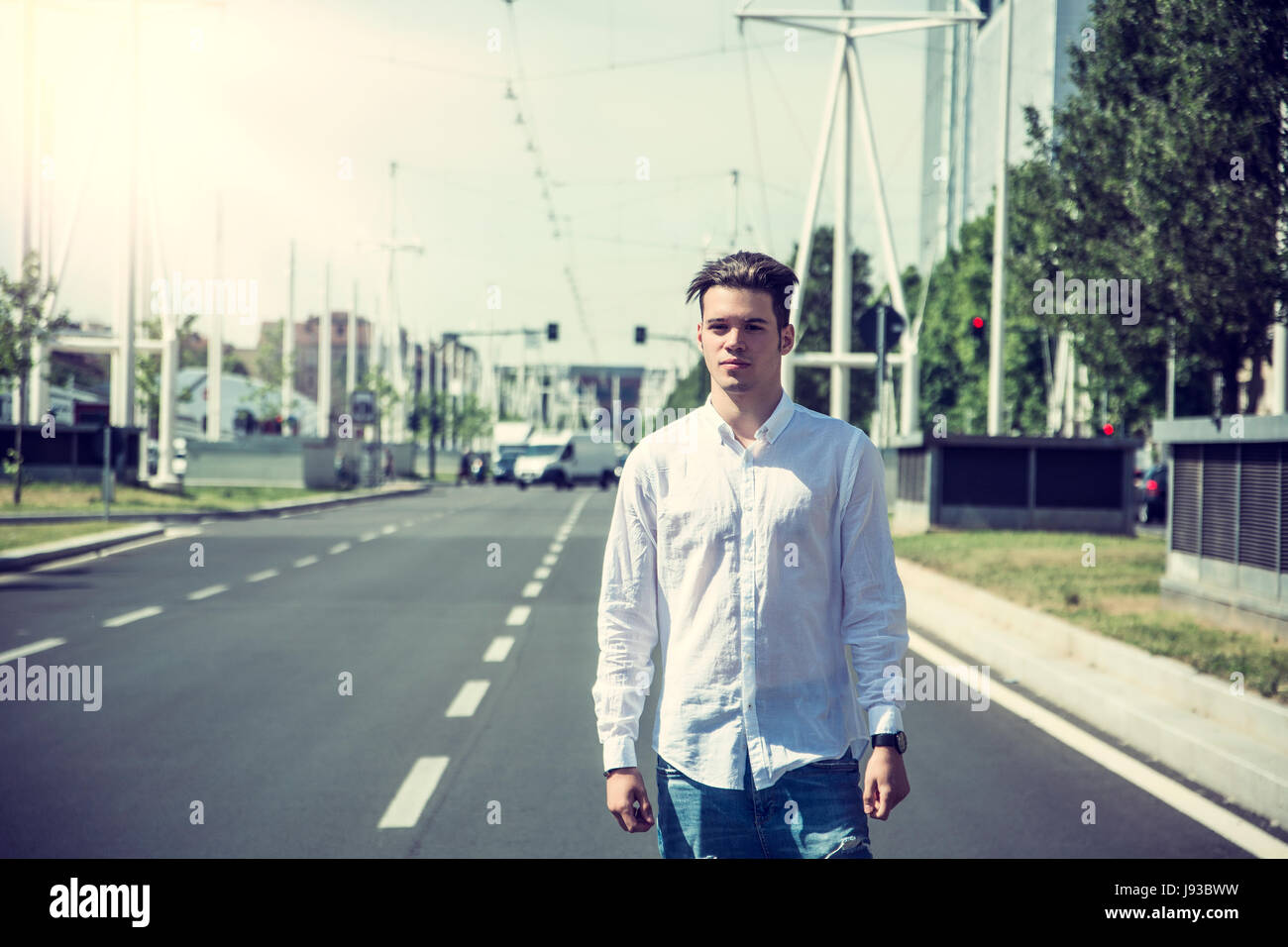 Attractive smiling man standing in the middle of city street Stock ...