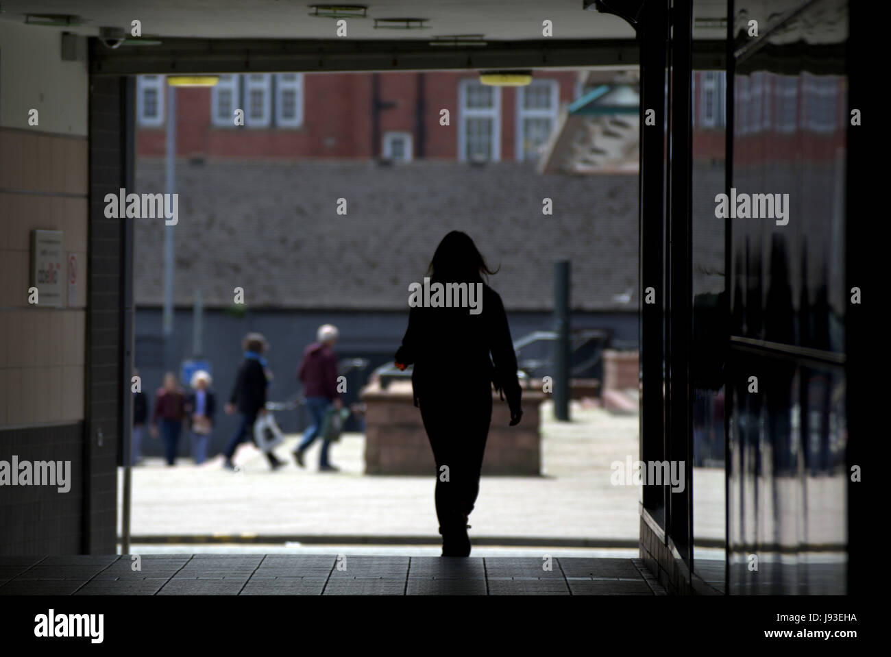 cityscape silhouette of woman leaving entrance to Argyle street train station Stock Photo
