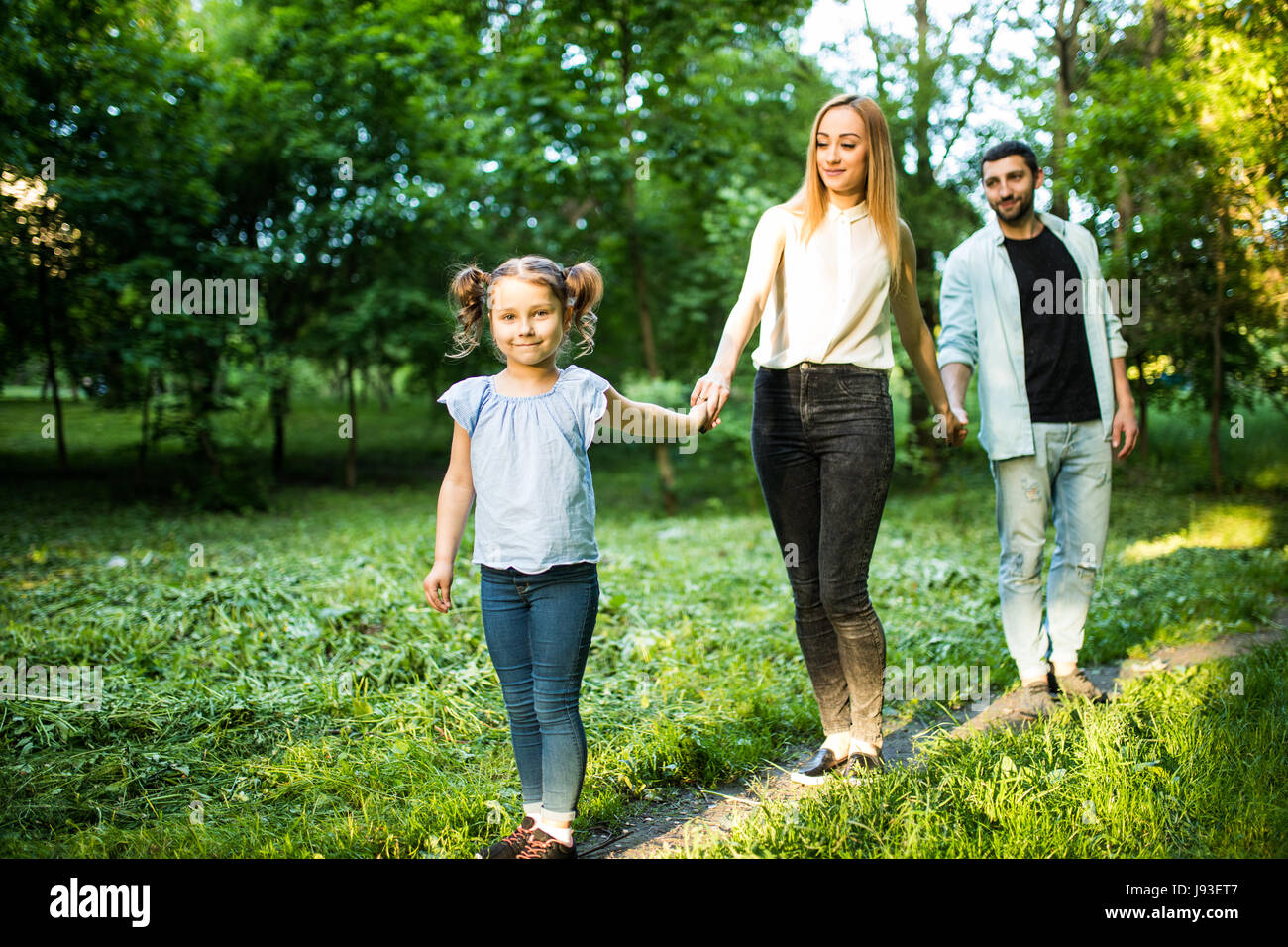 rear view of young family walking in forest Stock Photo - Alamy
