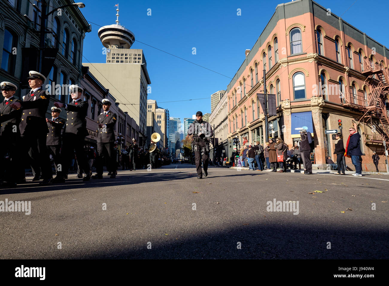 Vancouver, BC, Canada. 11th November, 2014. Heavily armed police patrol during Remembrance Day parade at Victory Square in downtown Vancouver. Stock Photo