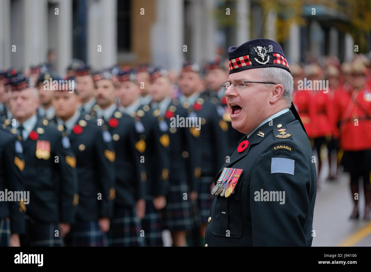 This officer shouts an order to the members of Highland Regiments during the Remembrance Day ceremony at Victory Square in downtown Vancouver. Stock Photo