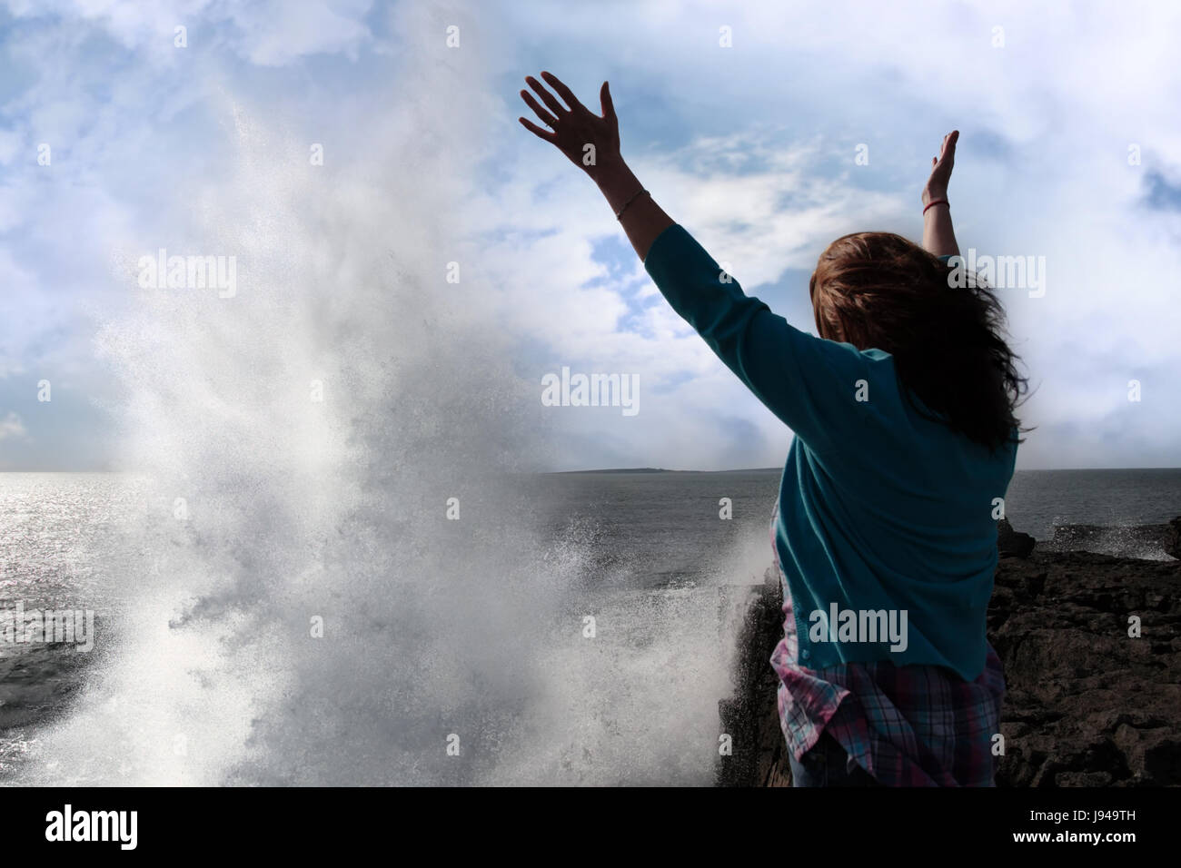 Woman on rock watching waves hi-res stock photography and images - Alamy