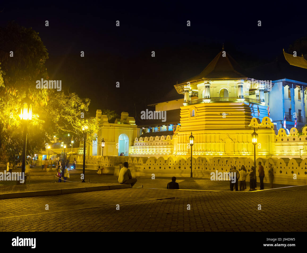 KANDY, SRI LANKA - NOVEMBER 28, 2016: Beautiful night illumination of Temple of Sacred Tooth attracts tourists and locals, on November 28 in Kandy. Stock Photo