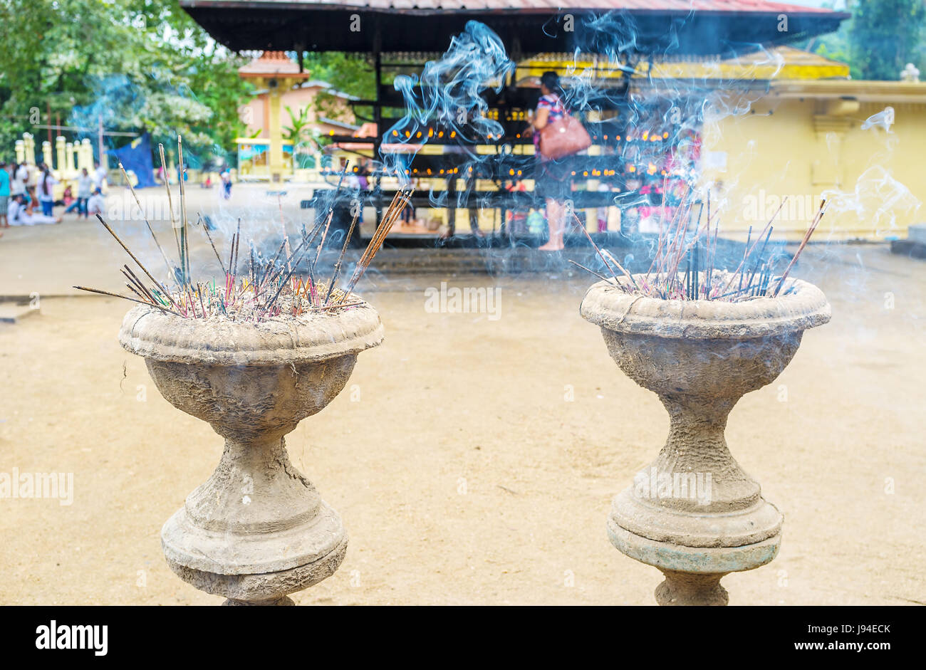 Two vases with burning aroma candle sticks located in Gatambe Viharaya