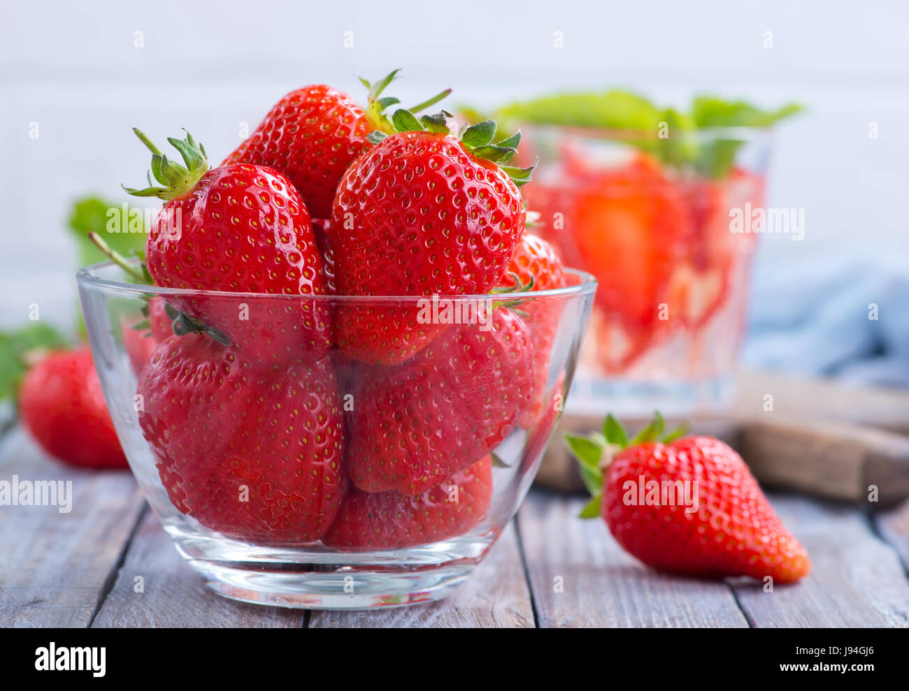 fresh strawberry in bowl and on a table Stock Photo - Alamy