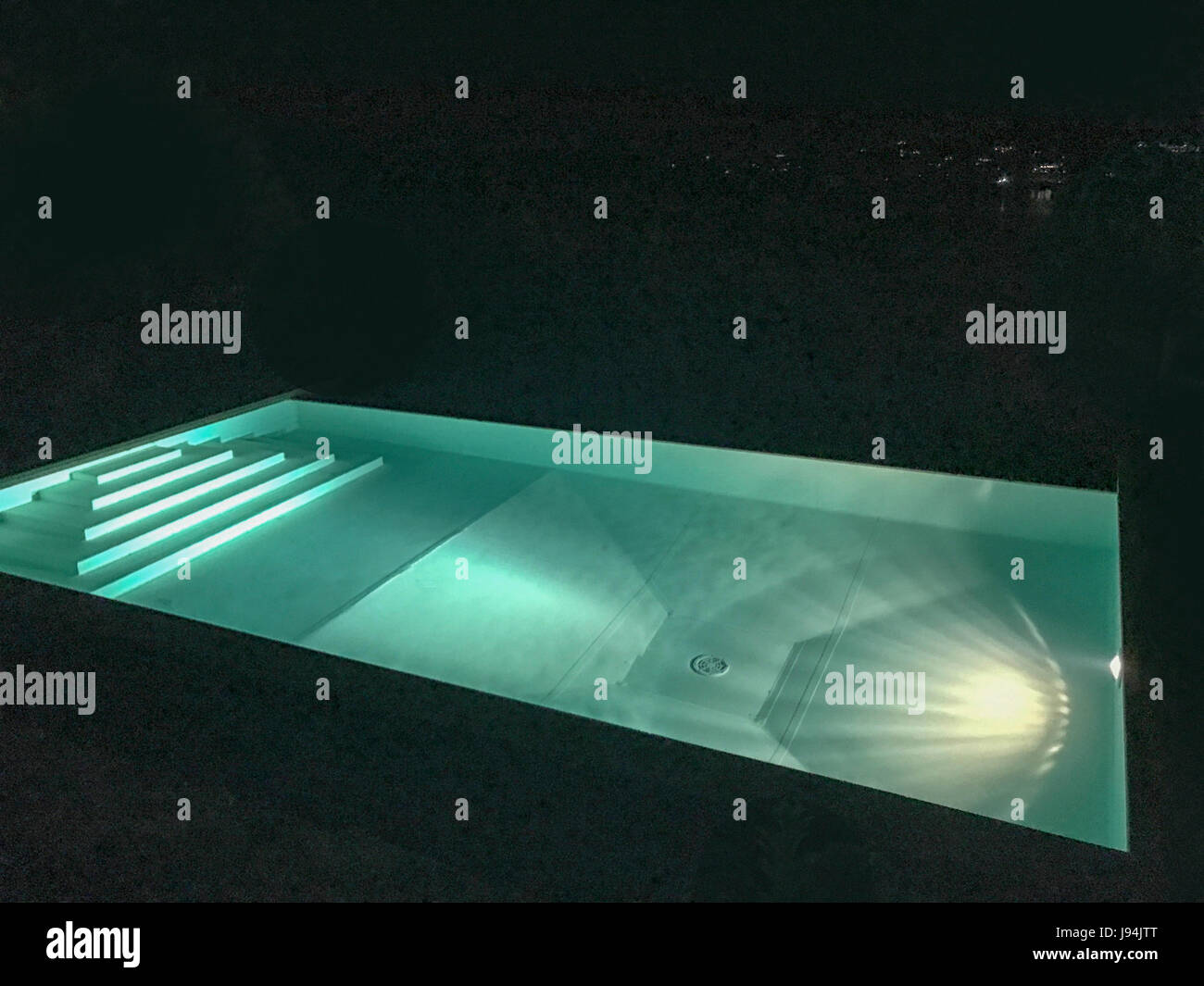 Luxury swimming pool at night Stock Photo