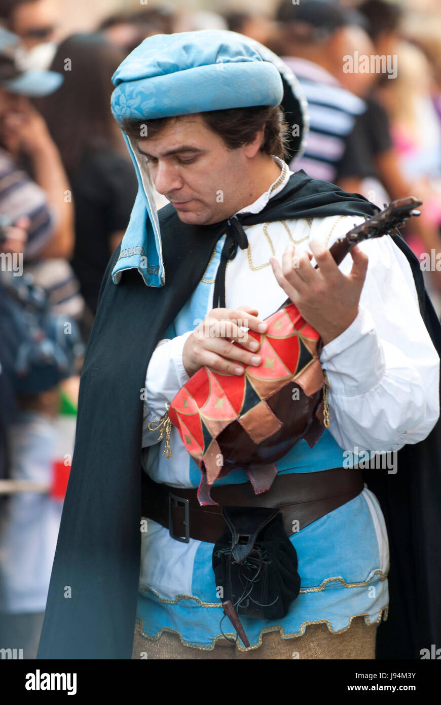 Medieval Young man playing the old guitar, lute parade del Palio. Stock Photo