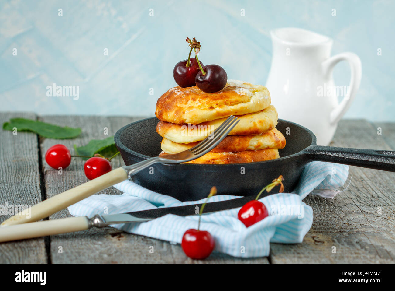 Homemade Cottage Cheese Pancakes With Cherries In A Cast Iron