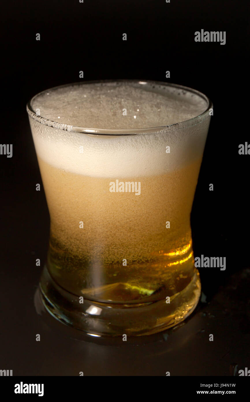 Beer in glass isolated on black background. Stock Photo