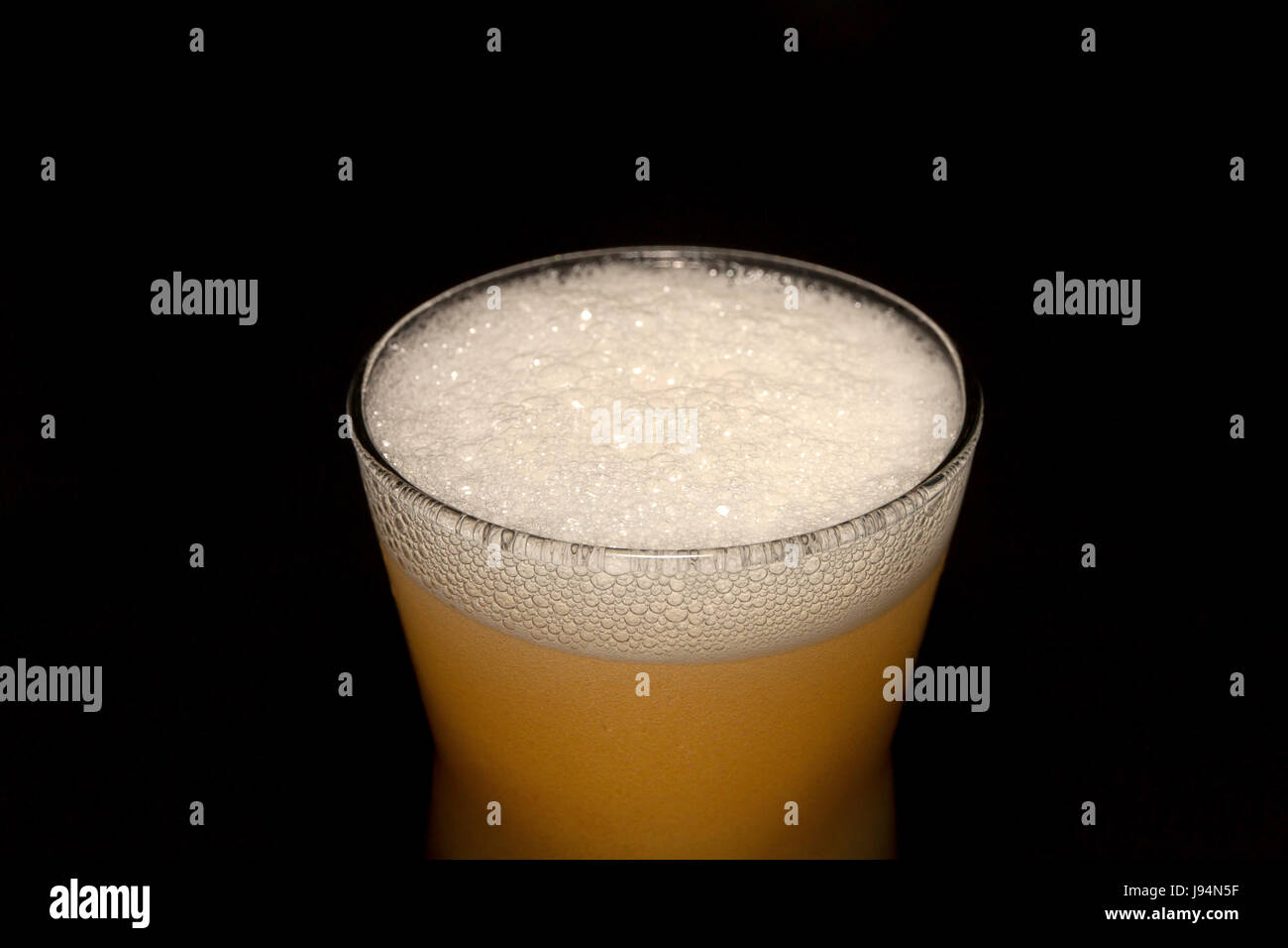 Beer in glass isolated on black background. Stock Photo
