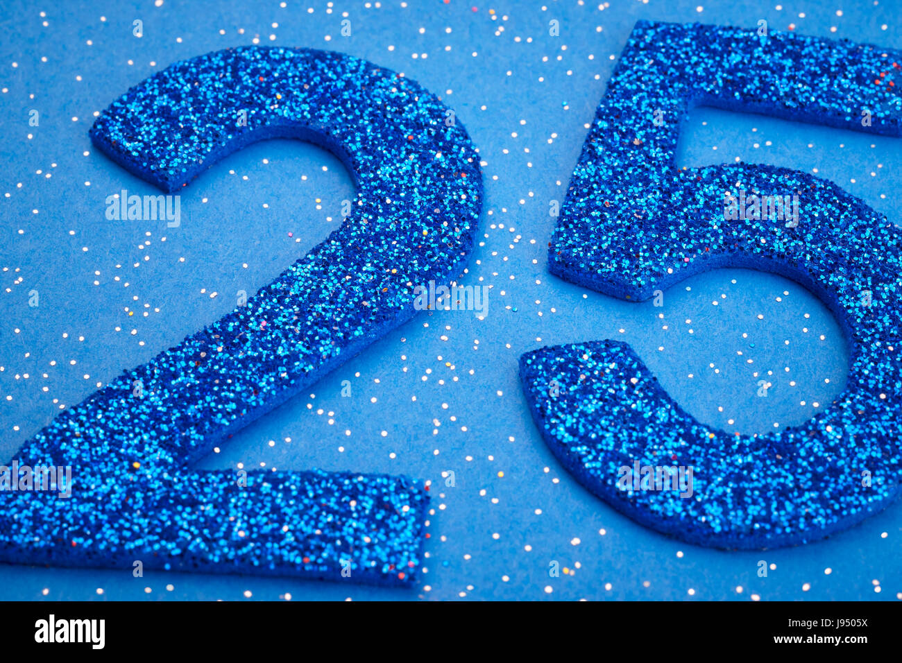 Number twentyfive blue color over a blue background. Anniversary ...