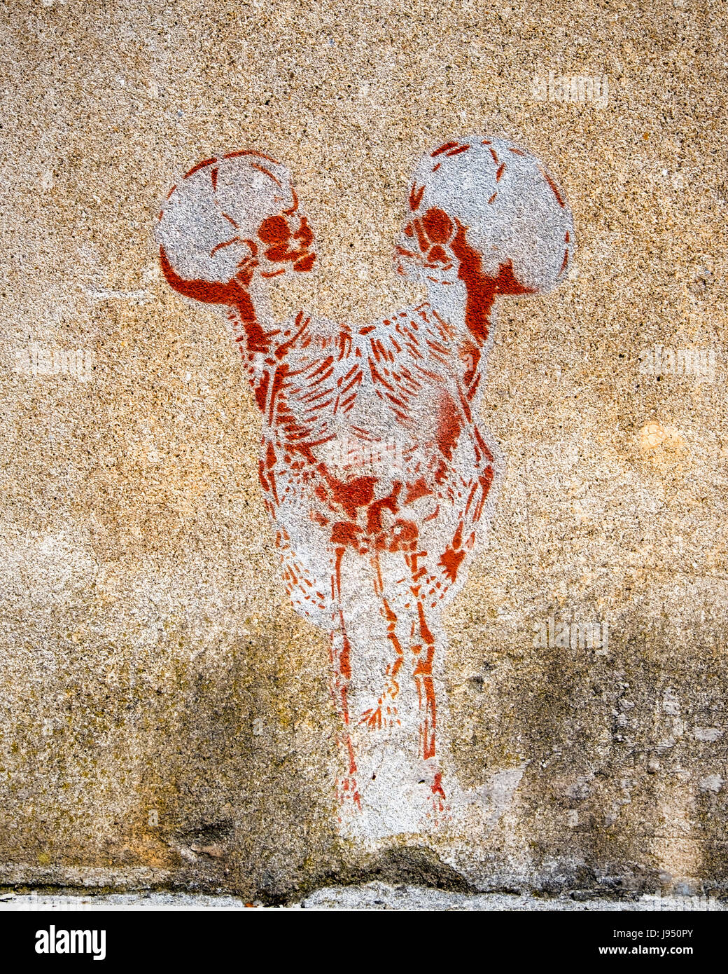 Venice,Italy,Castello. Urban street art. Two skeletons and skulls on weathered wall Stock Photo